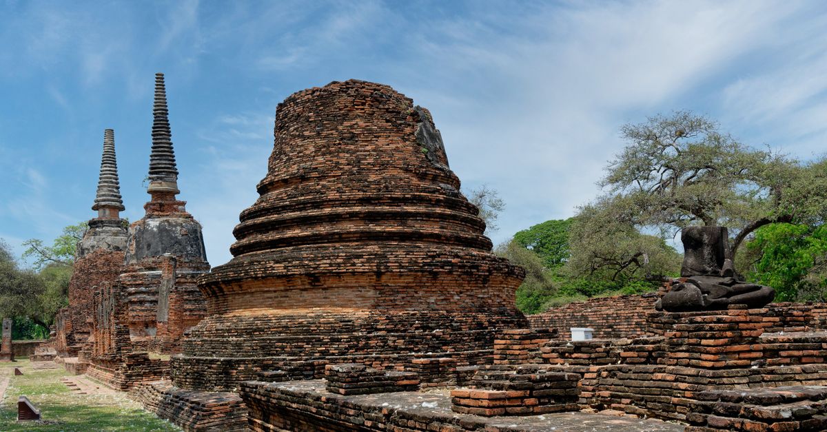 Explore the ancient brick ruins and Buddha statues at Ayutthaya, a UNESCO World Heritage Site in Thailand.