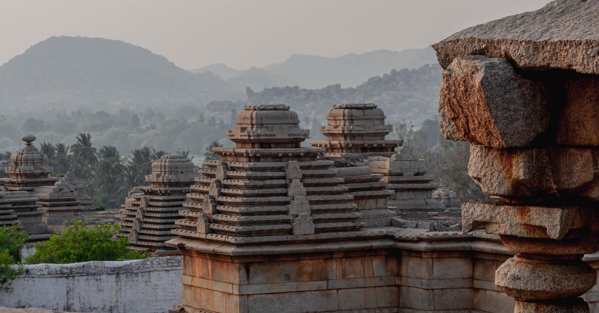 Serene view of ancient stone temples in Hampi, Karnataka, India during sunset.