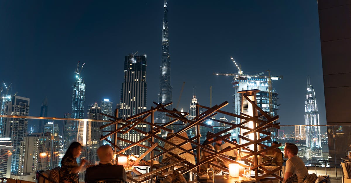Rooftop dining experience with stunning views of Dubai's skyline, showcasing the Burj Khalifa at night.