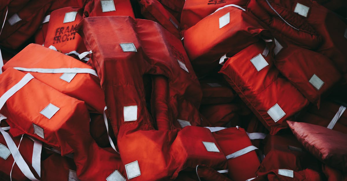A collection of red life jackets emphasizing safety and emergency preparedness.