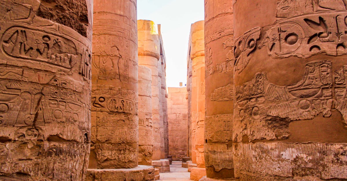 Explore the grandeur of ancient Egyptian columns adorned with hieroglyphic carvings.