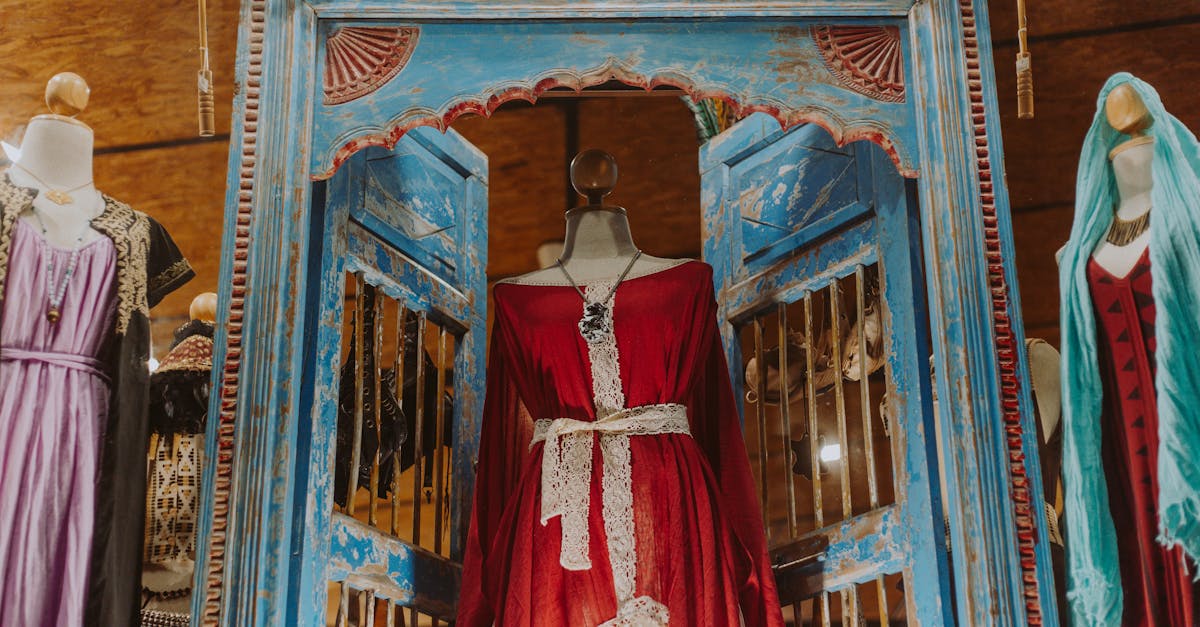 Charming display of vintage dresses on mannequins in a boutique setting.