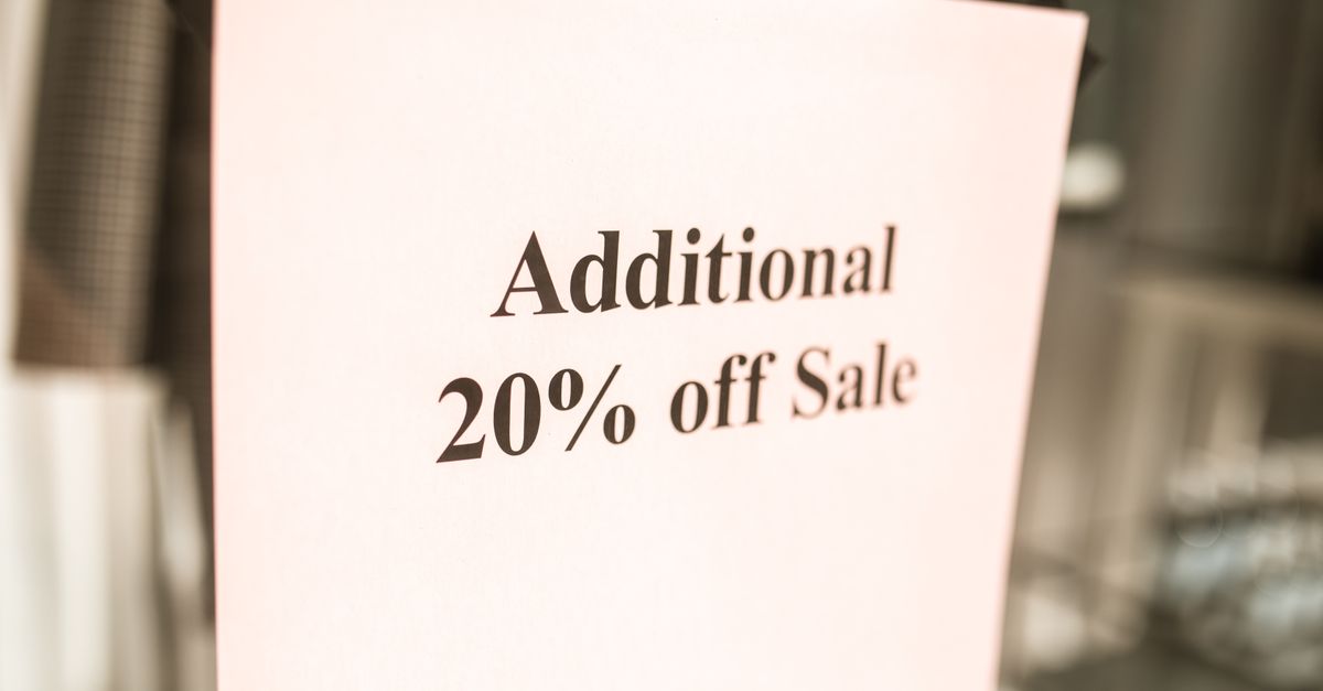 Close-up of a sale sign offering an additional 20% discount in a store window.