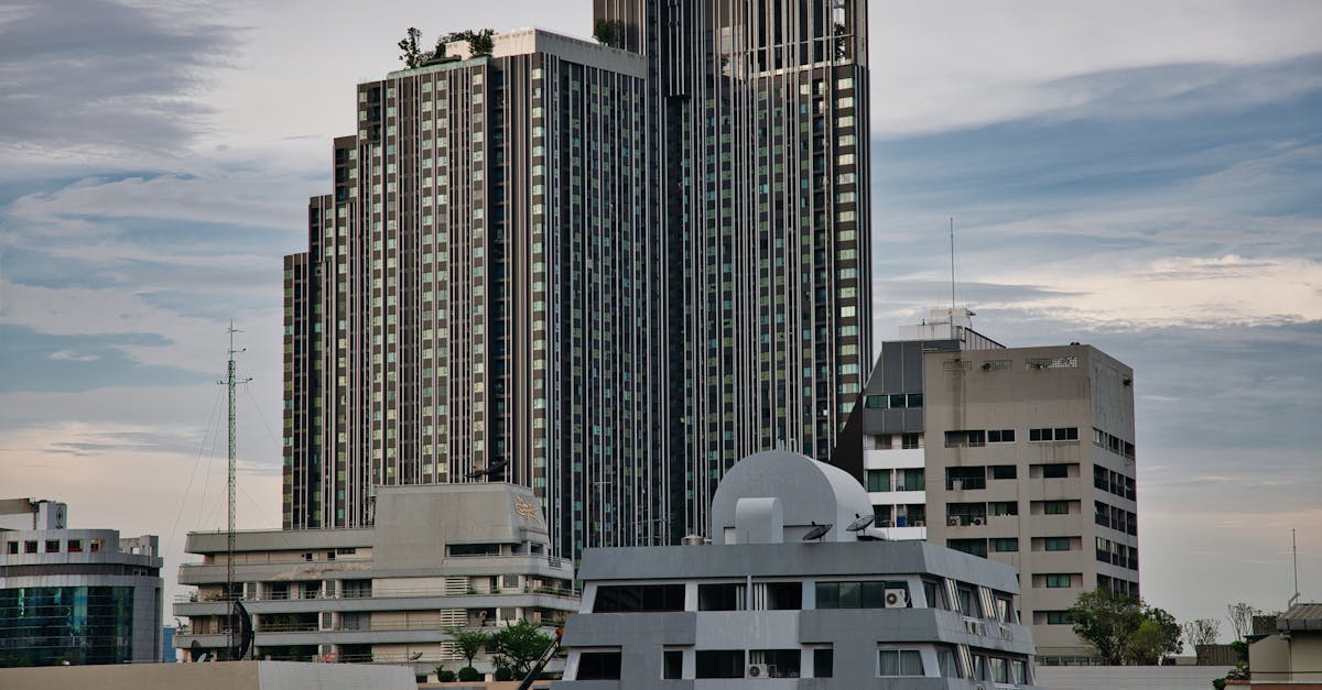 Skyline of modern high-rise buildings in Bangkok, Thailand with a moody sky.