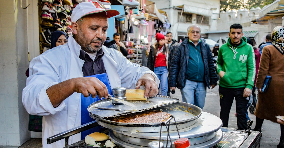 A street vendor prepares food in the bustling market of Tangier, Morocco.