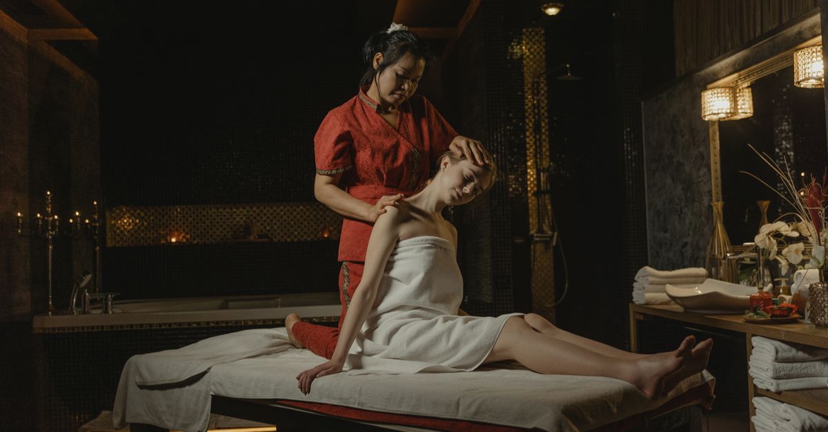 A serene spa massage session with a therapist providing a calming treatment indoors.