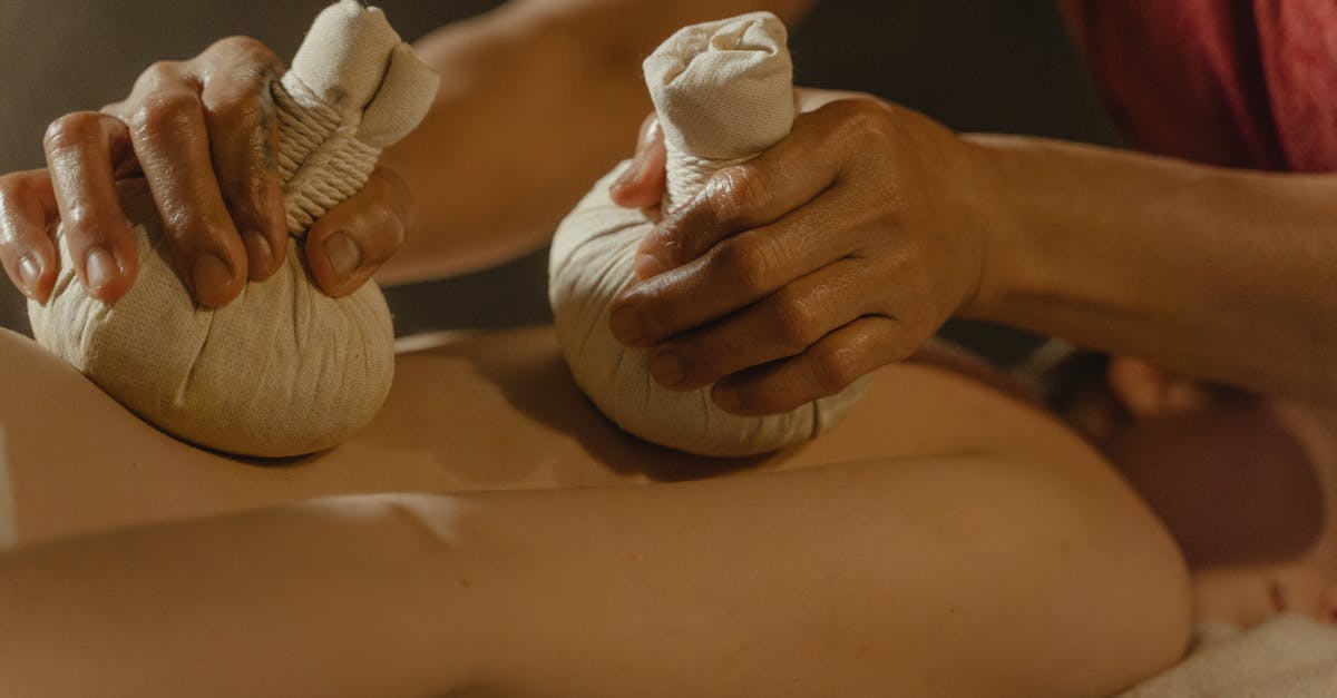 A tranquil scene of an herbal compress massage promoting relaxation and wellness indoors.