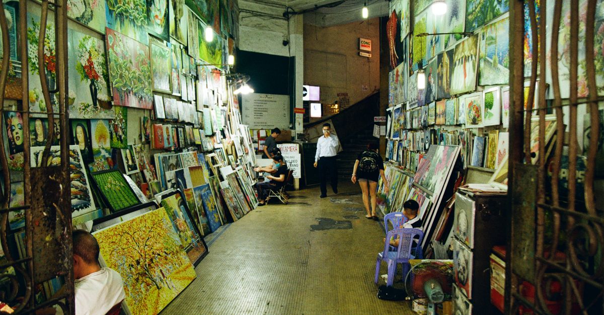 Vibrant art exhibition corridor in Ho Chi Minh City, featuring diverse paintings and visitors.