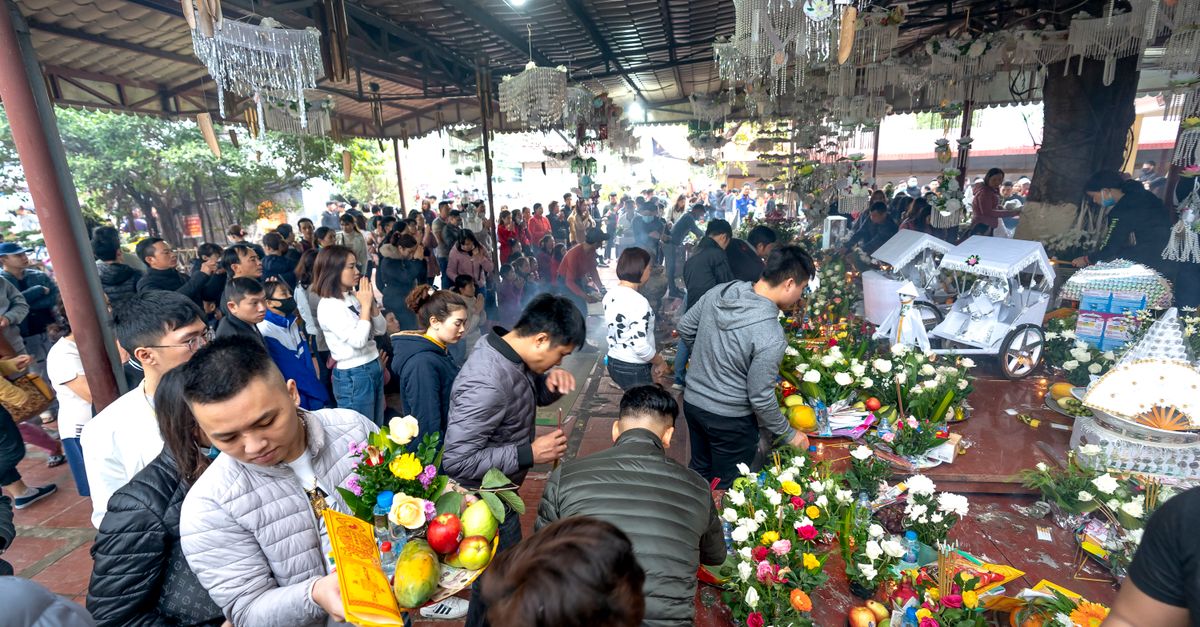 A bustling market scene with colorful flowers and fruit offerings, capturing cultural traditions.
