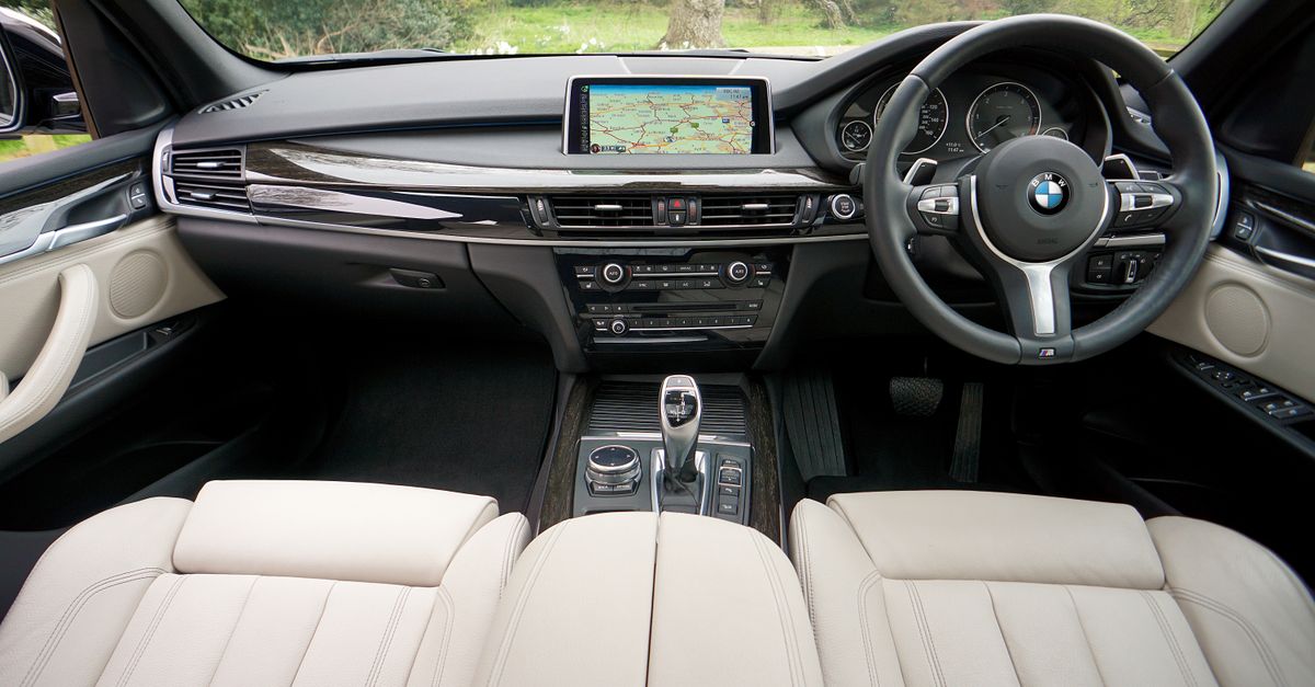 Explore the sleek interior of a BMW featuring a detailed dashboard and GPS navigation system.