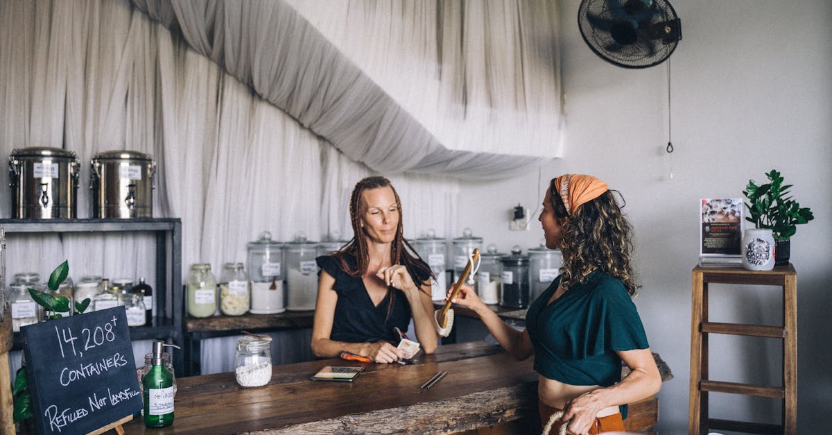 Two women shopping in an eco-friendly store with refillable glass jars and organic products.