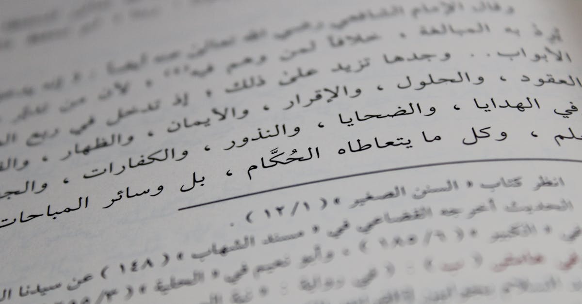 Close-up view of Arabic script on a book page, showcasing detailed calligraphy and text arrangement.