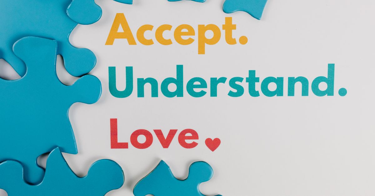 Colorful puzzle pieces with words 'Accept. Understand. Love.' symbolize autism awareness.