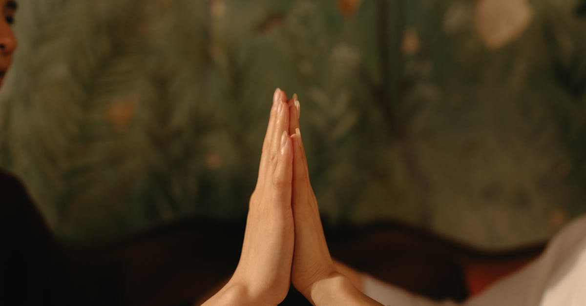 Two hands touching in calm setting symbolizing unity and connection.