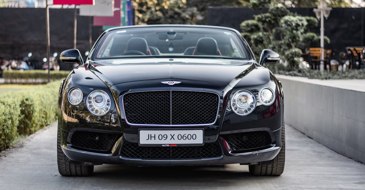 Front view of a sleek black Bentley Continental GT parked outdoors.