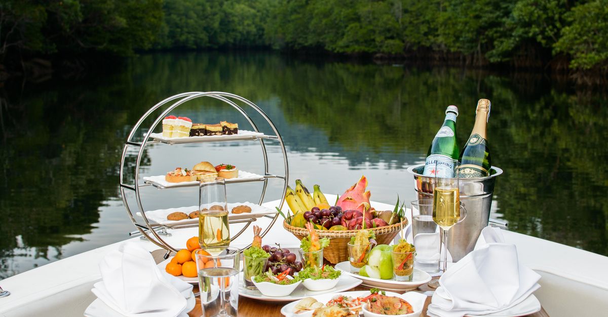 Enjoy a sumptuous riverside dining experience with diverse culinary delights and a serene view in Thailand.