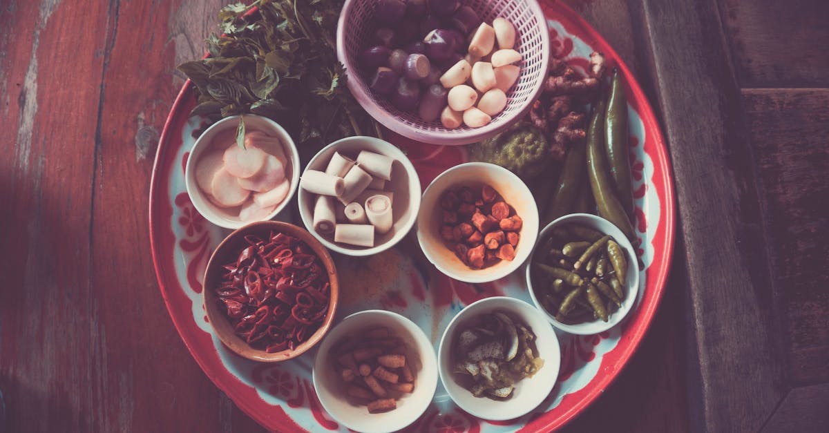 Colorful assortment of Thai cooking ingredients on a rustic wooden table.