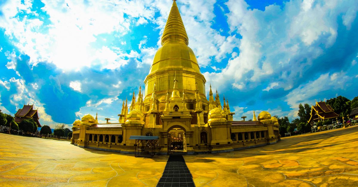 Stunning golden temple with intricate details under a vibrant blue sky, perfect for cultural exploration.